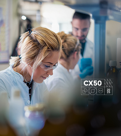 A scientist analyzing data on computer monitors in a lab.