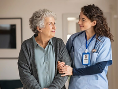nurse walking with elderly woman