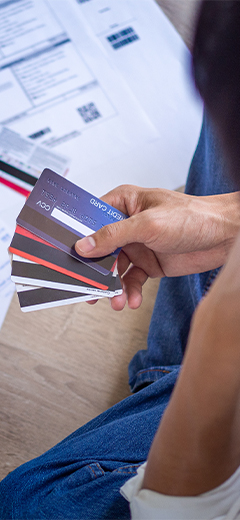 A person holding some credit cards 