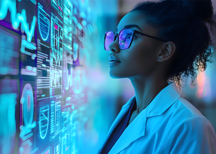 A lab technician looking at a digital wall