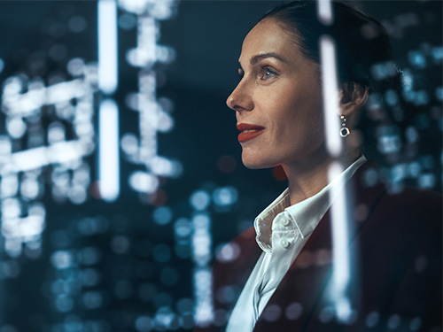 Successful Businesswoman in Stylish Suit Working on Top Floor Office Overlooking Night City. High Achievement Female CEO of Humanitarian Investment Fund, Human Face of Sustainable Corporate Governance