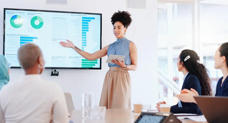 A woman presenting graphs to her collegues