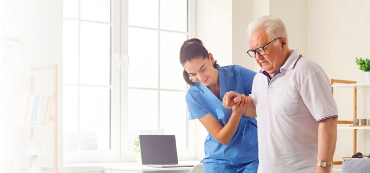 a patient trying to walk with the help of a nurse/doctor