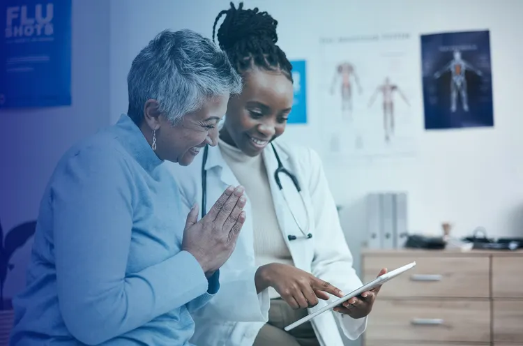 a doctor showing her tab to patient