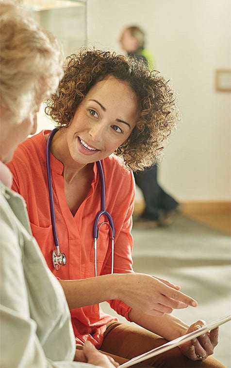 Doctor speaking to old woman