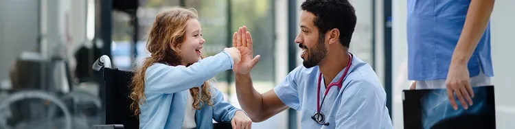 A child in wheelchair giving Hi-Fi to doctor