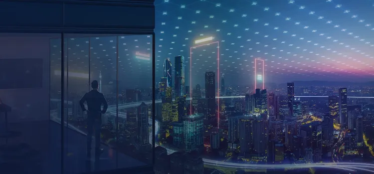 A man looking through a glass window towards number of buildings.
