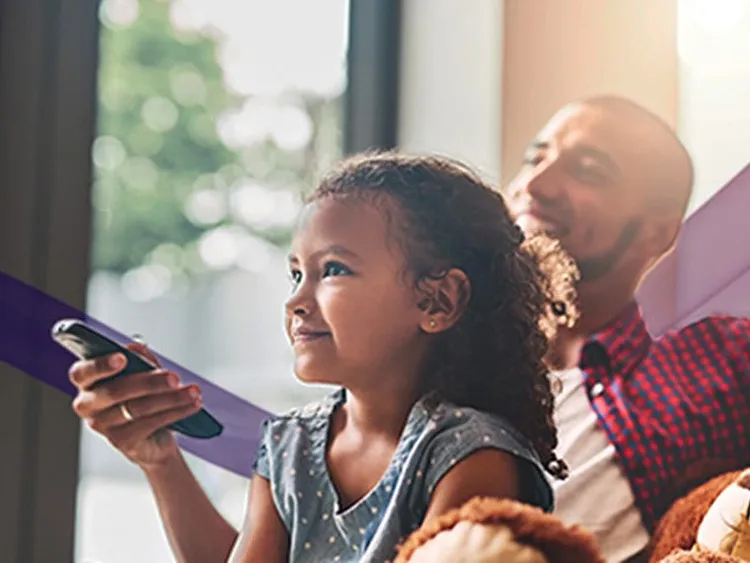 A family of three watching TV at home